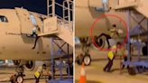 Moment airline worker falls out of plane door after ground crew moved stairs