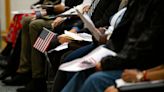 Scores of men and women become official citizens at Herrick District Library