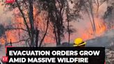 US: California wildfire sparked by a burning car triples in size in a day