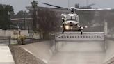 Raging floodwaters sweep away man trying to rescue dog, California video shows