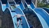 'Super dad' scrambles up water slide to rescue stranded daughter