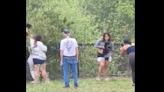 Group caught on camera pulling bear cubs from tree to take pictures