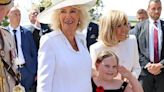 Camilla ambushed by adorable young fan that clings to her while Marcon takes pic