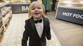 Dapper toddler in tuxedo steals show as Queen visits his dad's bakery in Belfast