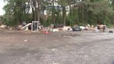 Business owners say illegal dumping making busy shopping center parking lot look like ‘junkyard’