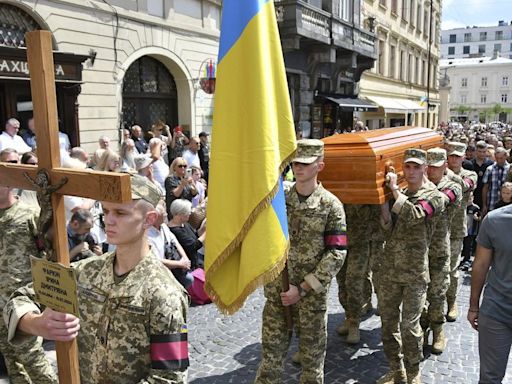 Thousands attend funeral of former Ukrainian lawmaker killed in Lviv