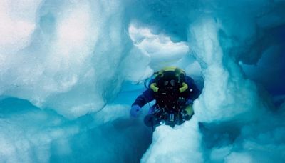Photos show what cave divers discovered when they swam inside an iceberg the size of Jamaica. Today, it's gone.