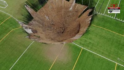 VIDEO: Sinkhole swallows part of a soccer field after underground mine collapses