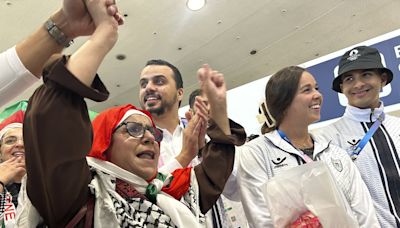 Palestinian Olympic team greeted with cheers and gifts in Paris