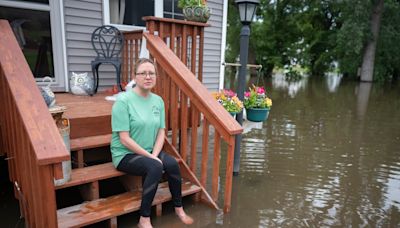 Swollen river claims house next to Minnesota dam as flooding and extreme weather grip the Midwest