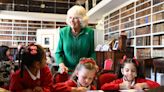 Queen Camilla meets children and volunteers at historic library