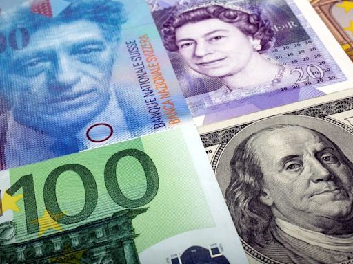 Dollar rises, pound, Swiss franc drop on busy central bank day