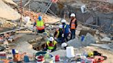 Rescuers contact some workers alive in the rubble of a deadly building collapse in South Africa