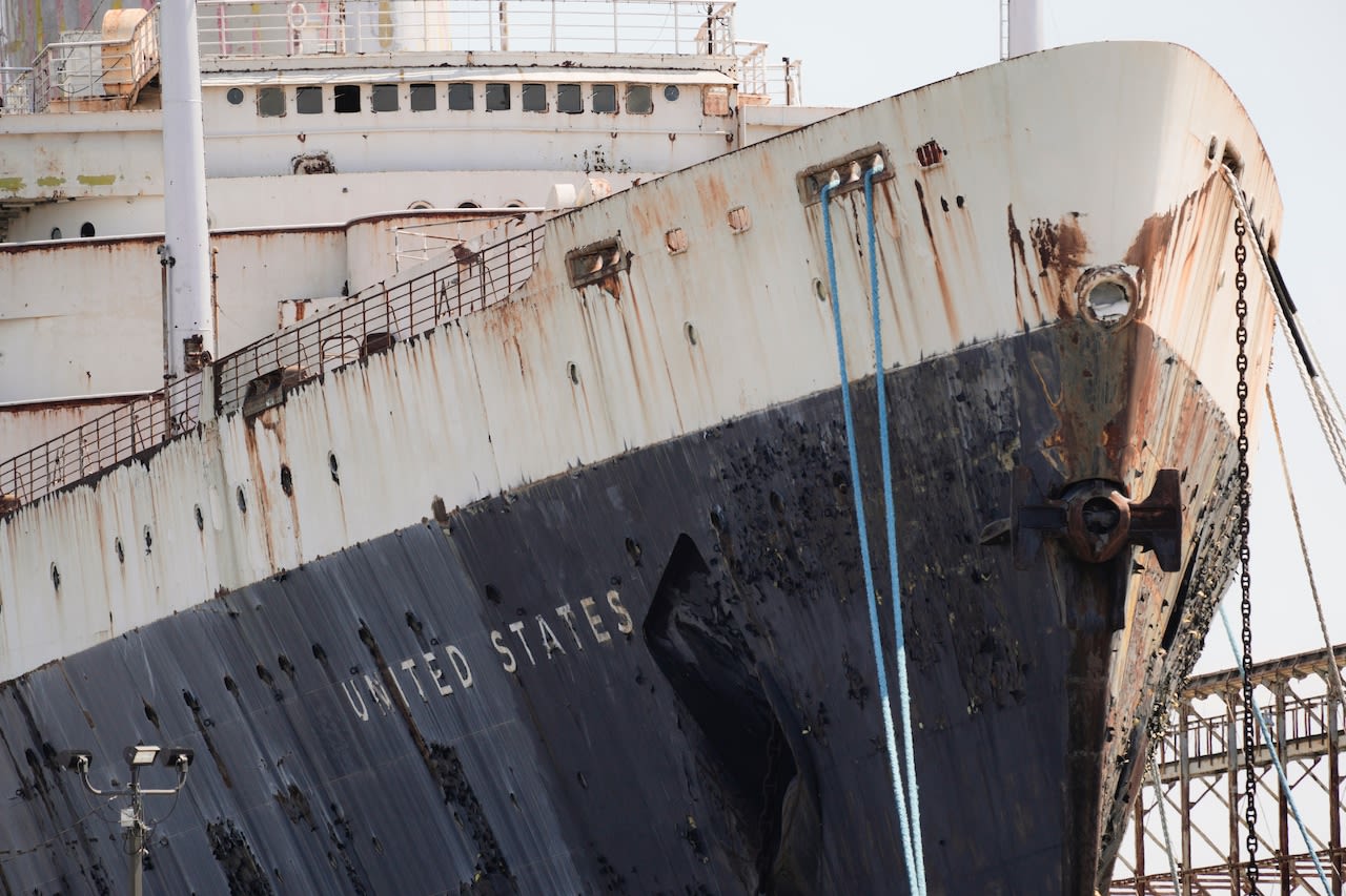 Historic ocean liner, destined to become a giant artificial reef, will stay docked across from N.J. for now