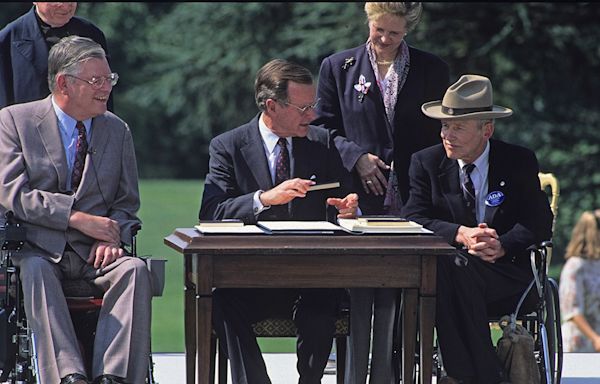 On this day in history, July 26, 1990, President George H.W. Bush signs Americans with Disabilities Act