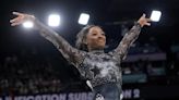 The Latest: Simone Biles leads her qualifying group after leg discomfort scare