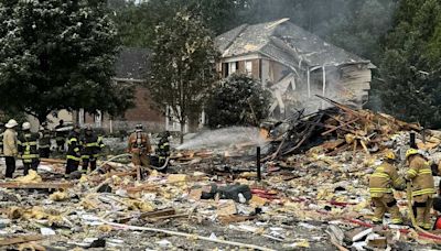 Firefighters search for victims in apparent house explosion