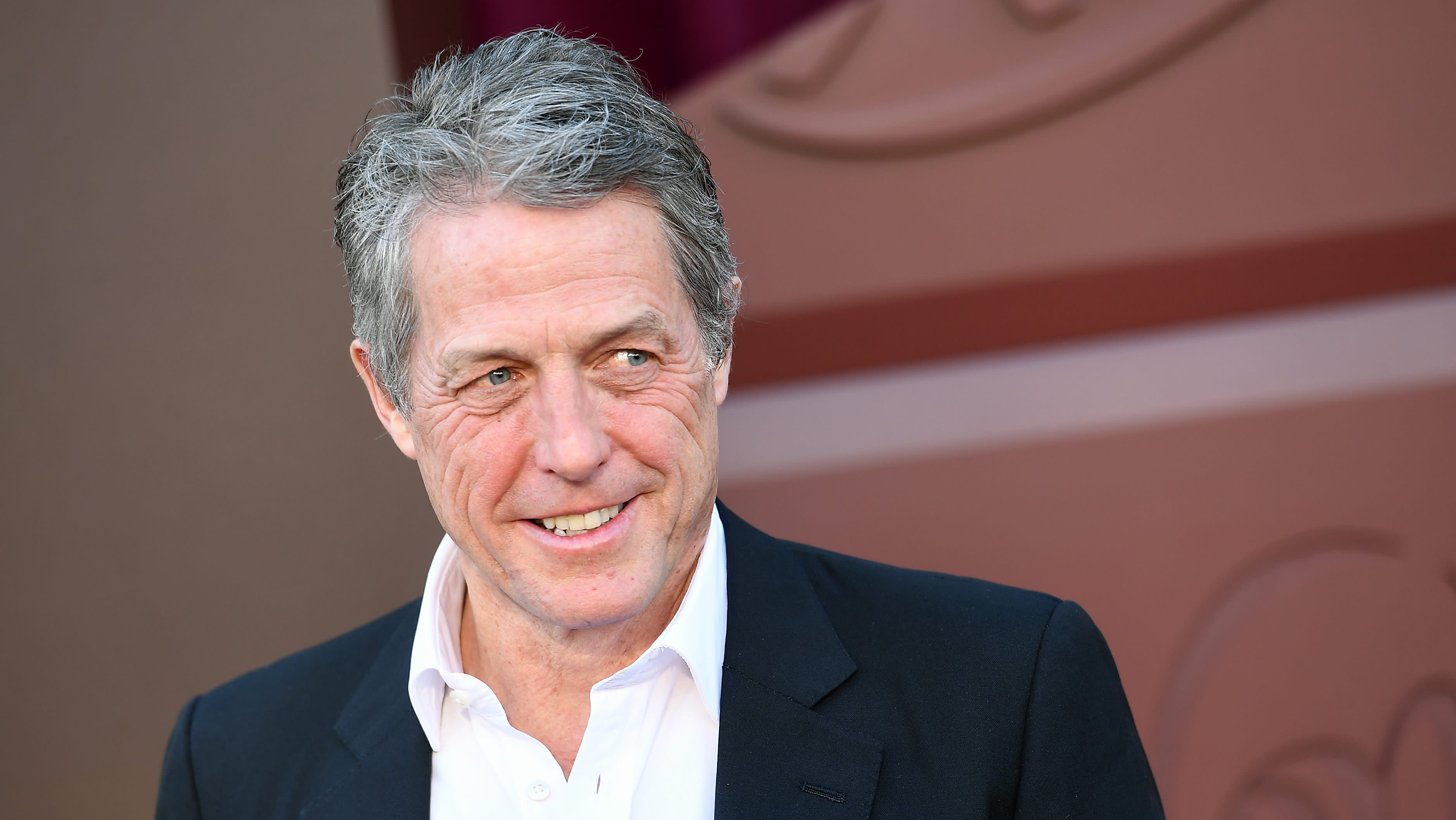 Hugh Grant Recalls Role That Saved His Career & Roles He “Turned Down”