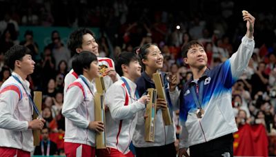 North Korean, South Korean athletes take selfies as they share an Olympic podium