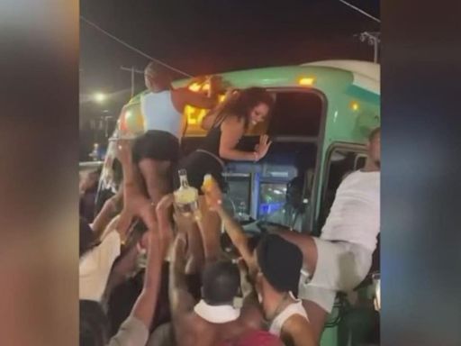 Women climb Detroit bus to twerk during street takeover by more than 100 party-goers