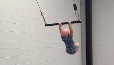 Incredible moment 22-month-old toddler swings from a trapeze