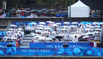 Rainy Paris Olympic parade dampens many spectators' spirits