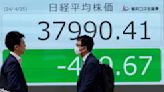 Stock market today: Asian benchmarks mostly slide as investors focus on earnings