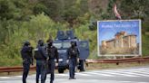 Kosovo mourns a slain police officer, some Serb gunmen remain at large after a siege at a monastery