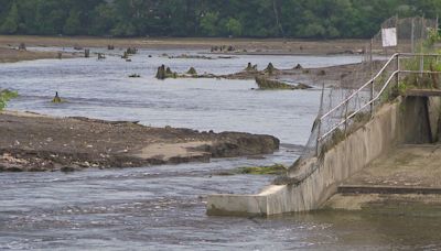 Crowds gather at Manawa Mill Pond Dam to see erosion damage