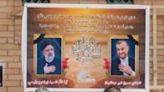 Portraits of Iran's President Ebrahim Raisi, on the left, and Foreign Minister Hossein Amir-Abdollahian on a wall in the central Iraqi holy city of Najaf