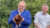 Sir Ed Davey warns water companies to invest as he feeds chickens on farm