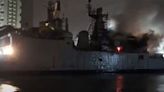 Indian frigate left floating on its side after fire breaks out during repairs