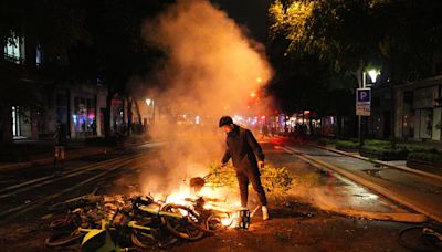 Violent clashes break out in Paris after shock exit poll results in France’s general election