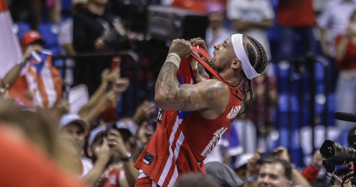 Jose Alvarado celebrated Puerto Rico's Olympics-clinching win by jumping onto scorer's table