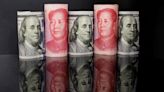 Analysis-Chinese companies hang onto dollars, hedge to prepare for volatile yuan