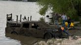 Diver recovering after two vehicles were removed from the Saginaw River in Bay City