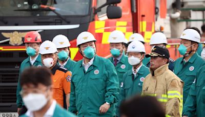 South Korean rescuers search burned factory after a blaze killed 22, mostly Chinese migrants