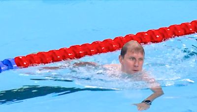 At Olympic swimming heat, 'Bob the Cap Catcher' saves the day