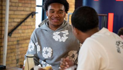 Minnesota running back Darius Taylor, left, meets with Slice Pizza co-owner Adam Kado about a deal at Team IFA headquarters on June 21, 2024, in Minneapolis.