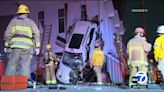 4 people rescued after crash leaves car propped up vertically against building in Vernon