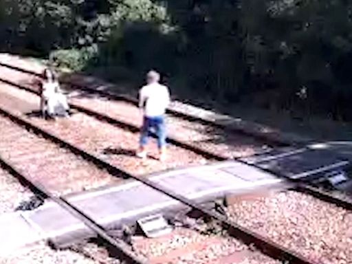 Photoshoot on railway tracks and youths play 'chicken' with trains