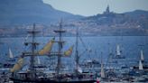 A ship carrying the Olympic torch arrives in Marseille amid fanfare and high security