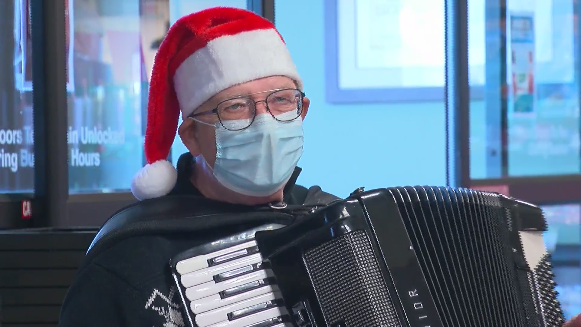 Accordion player spreads Christmas cheer