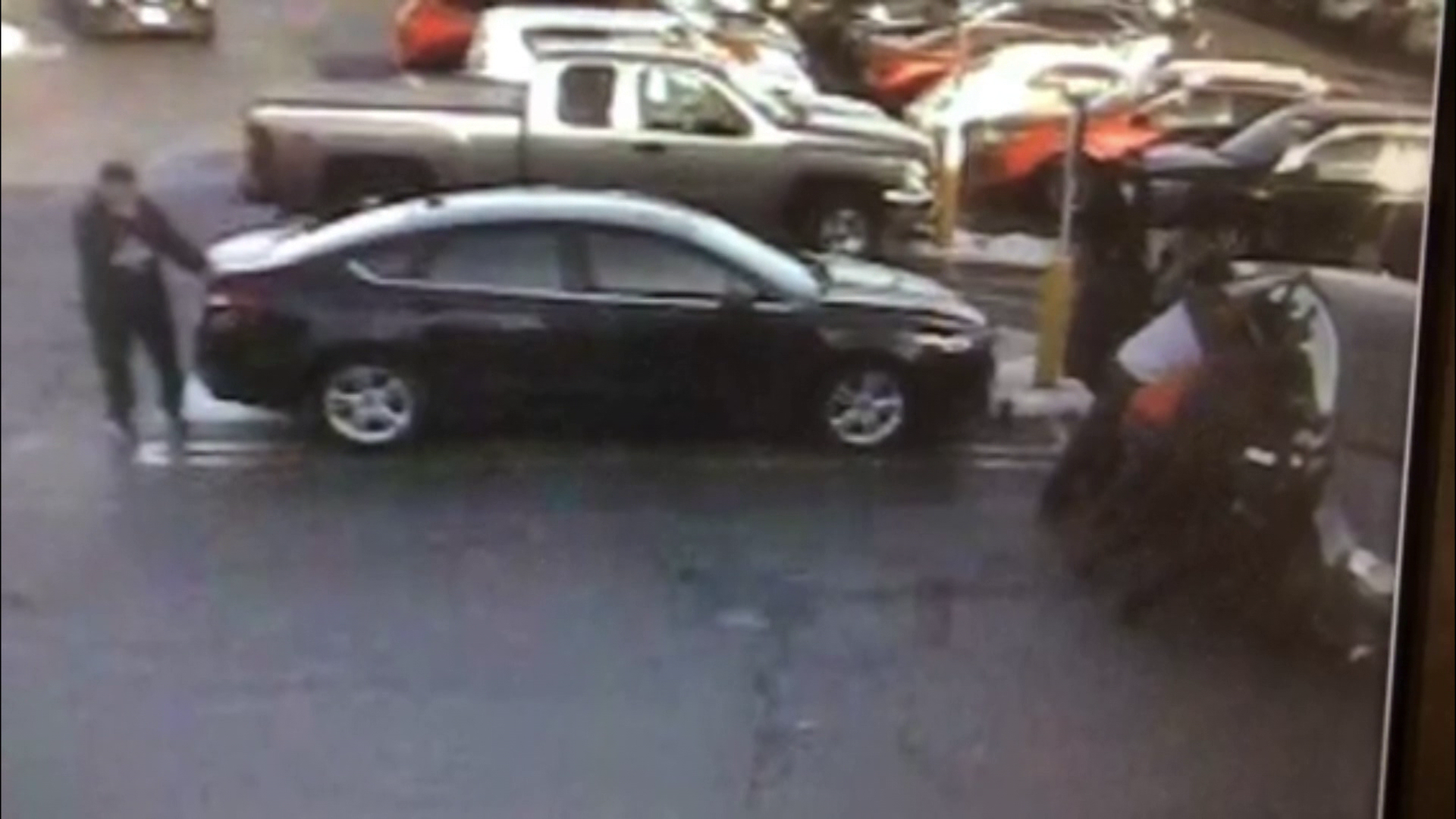 Surveillance video shows a group lifting a car from a woman in Quincy