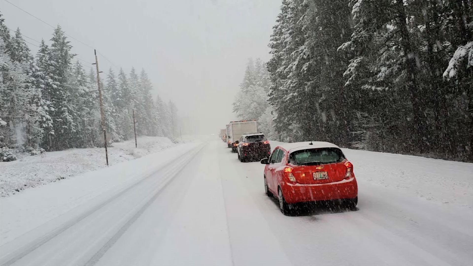 Health workers sitting in the snow vaccinate drivers