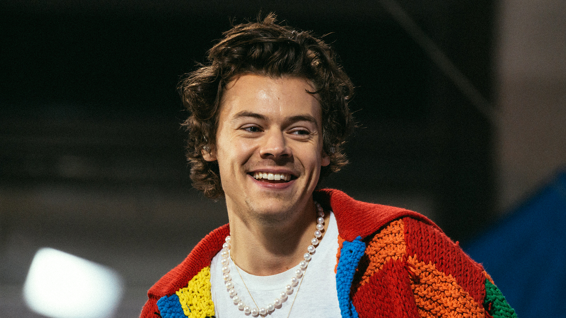 harry styles smiling at the camera 2022