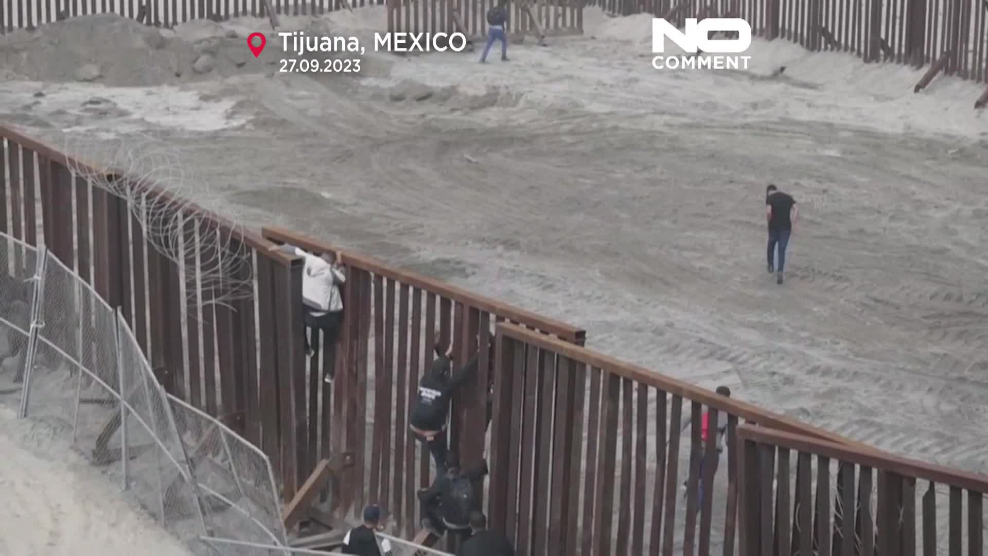 WATCH Dozens of migrants attempt to reach US climbing Tijuana border fence