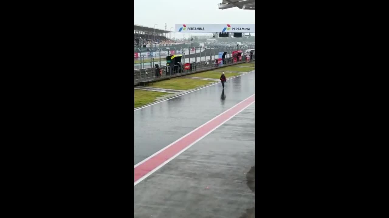Female rain handler tries to stop a downpour at the Mandalika Indonesia Moto GP