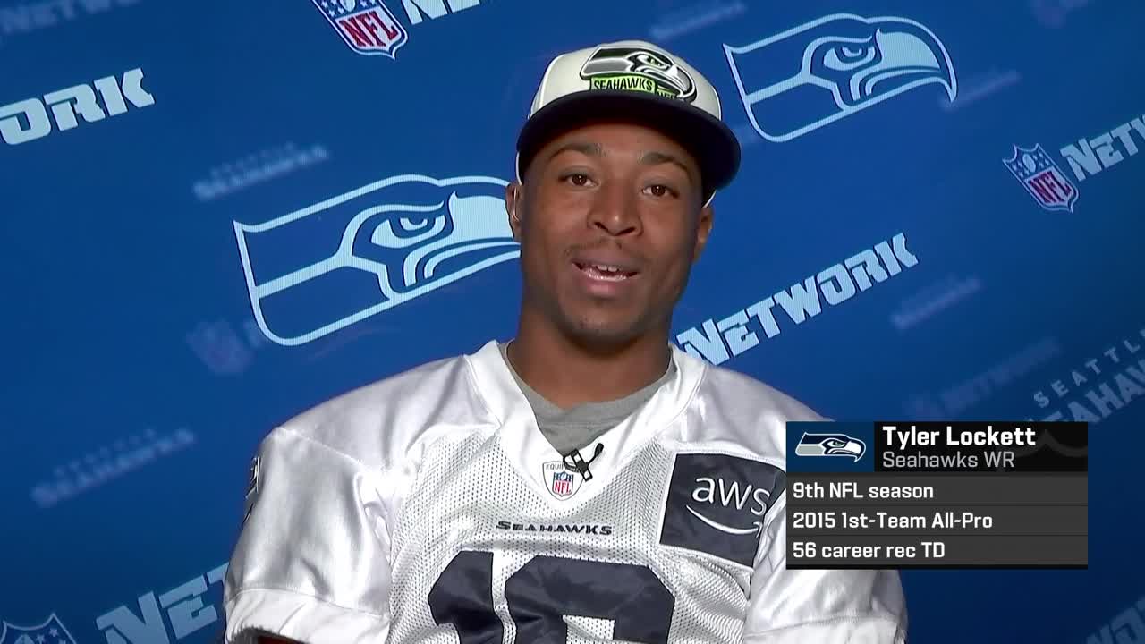 Wide receiver Tyler Lockett of the Seattle Seahawks smiles between