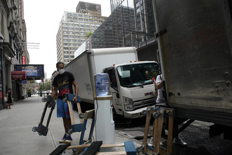 NEW YORK, NEW YORK - SEPTEMBER 02: Movers wearing protective masks unload a truck as the city continues Phase 4 of re-opening following restrictions imposed to slow the spread of coronavirus on September 2, 2020 in New York City. The fourth phase allows outdoor arts and entertainment, sporting events without fans and media production (Photo by John Lamparski/Getty Images)